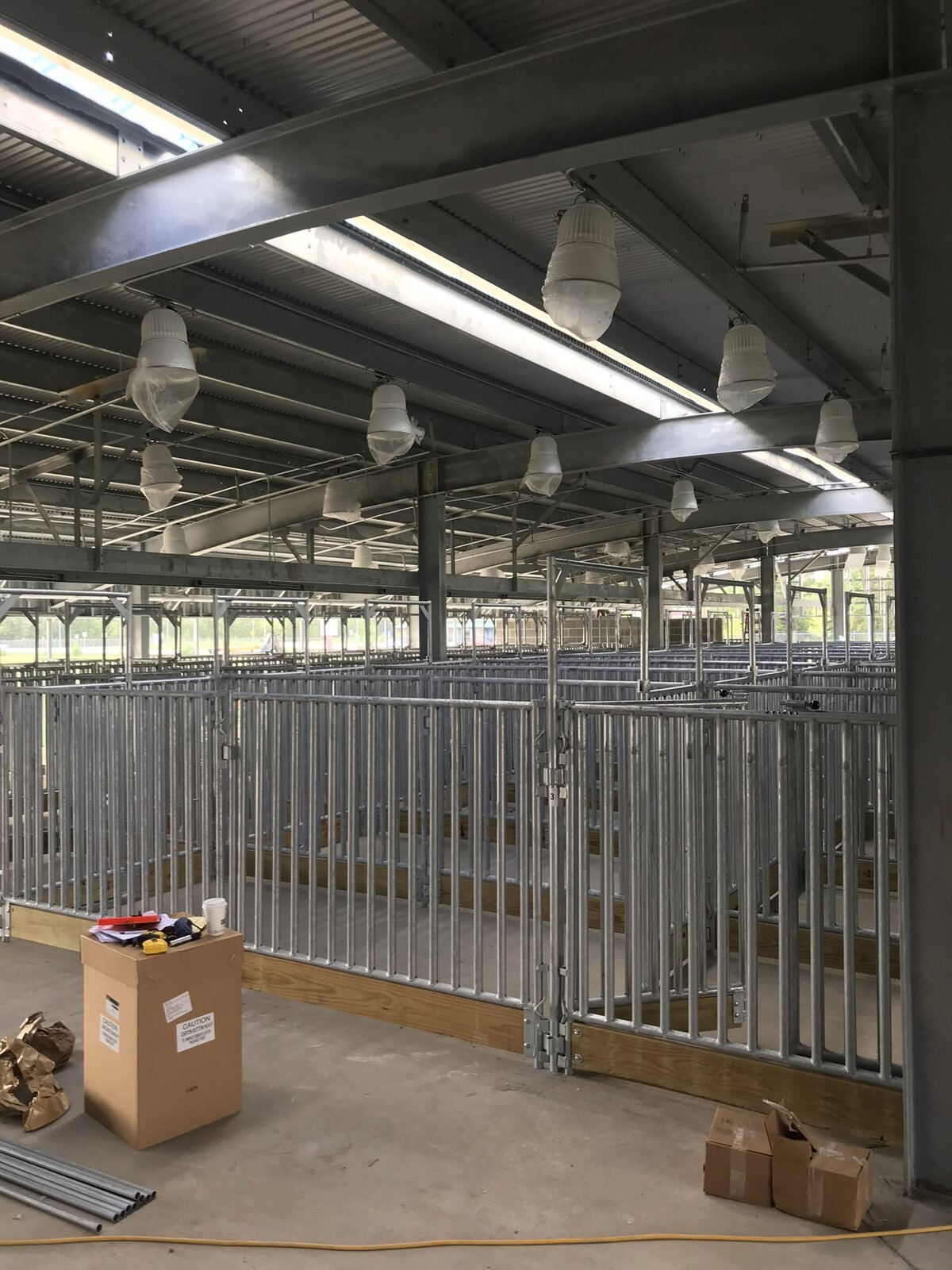 Rows of galvanized show pens under a covered Pearland ISD barn